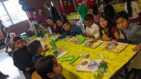 Students dress up and get served a fine meal. 